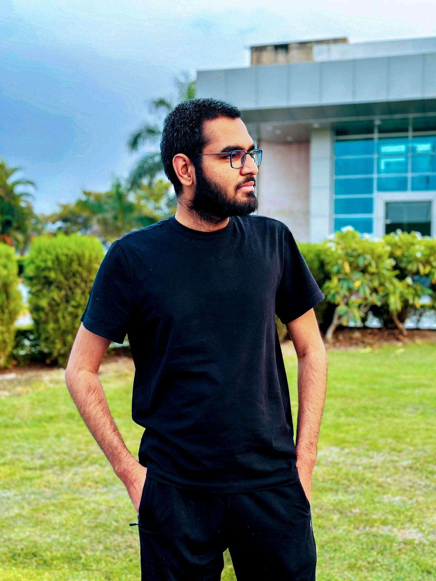 a man standing in front of a building with his hands on his hips